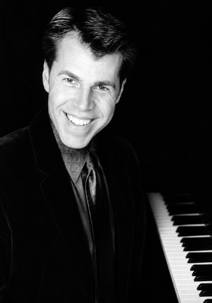 Black and white portrait of Michael Kevin Walsh at the piano keys